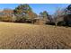 Brick house sits on a large, grassy lot with trees at 1417 Iris Lake Rd, Mcdonough, GA 30252