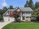 Two-story home with gray roof, stone accents, and landscaped yard at 1012 Jubilee Way, Powder Springs, GA 30127