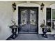 Elegant double doors with ornate ironwork and flanking planters at 1012 Jubilee Way, Powder Springs, GA 30127