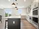 Modern kitchen with island, stainless steel appliances, and hardwood floors at 37 Ridgeline Nw Way, Cartersville, GA 30121