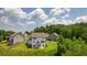 Aerial view of a two-story house with a deck, situated on a grassy lot with woodland in the background at 37 Ridgeline Nw Way, Cartersville, GA 30121