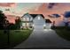 Two-story farmhouse with driveway at sunset at 37 Ridgeline Nw Way, Cartersville, GA 30121