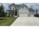 Two story home with white siding, three car garage, and front porch at 37 Ridgeline Nw Way, Cartersville, GA 30121