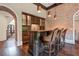 Custom wet bar with brick feature wall and dark wood cabinetry at 4317 Oglethorpe Nw Loop, Acworth, GA 30101
