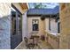 Private stone patio with wrought iron furniture and French doors at 4317 Oglethorpe Nw Loop, Acworth, GA 30101