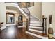 Elegant curved staircase with wrought iron railing in a spacious foyer at 4317 Oglethorpe Nw Loop, Acworth, GA 30101