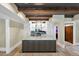 Basement kitchenette with large island and exposed wood beams at 4317 Oglethorpe Nw Loop, Acworth, GA 30101