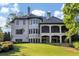 Home's back features a large covered patio and lush lawn at 4317 Oglethorpe Nw Loop, Acworth, GA 30101
