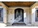 Elegant home entrance with arched double doors and stone facade at 4317 Oglethorpe Nw Loop, Acworth, GA 30101