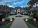 Stunning home exterior with circular driveway and fountain at dusk at 4317 Oglethorpe Nw Loop, Acworth, GA 30101
