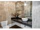 Elegant powder room features a marble sink, dark vanity, and decorative mirror at 4317 Oglethorpe Nw Loop, Acworth, GA 30101