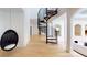 Hallway featuring a modern spiral staircase and light wood floors at 3206 Arden Rd, Atlanta, GA 30305