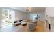 Bright living room with hardwood floors, fireplace, and large window offering garden views at 3206 Arden Rd, Atlanta, GA 30305