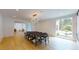 Bright dining room features hardwood floors, a large table and access to the living room at 3206 Arden Rd, Atlanta, GA 30305