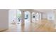 Long hallway with light hardwood floors and arched doorways leading to other rooms at 3206 Arden Rd, Atlanta, GA 30305