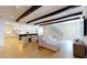 Open living area with exposed beams, hardwood floors, and adjacent kitchen at 3206 Arden Rd, Atlanta, GA 30305