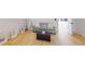 Light-filled sitting room featuring hardwood floors, a comfy couch, and tasteful artwork at 3206 Arden Rd, Atlanta, GA 30305