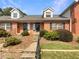 Brick townhouse with a small front yard and landscaping at 3266 Henderson Mill Rd # C, Atlanta, GA 30341