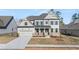 Charming two-story home with a welcoming front porch and landscaped yard at 739 Marlay Sw Ln, Powder Springs, GA 30127