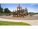 A playground with slides, climbing wall, and benches in a community area at 739 Marlay Sw Ln, Powder Springs, GA 30127