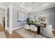 Elegant dining room featuring hardwood floors, a statement art piece, and a chandelier at 3829 Tielman St, Snellville, GA 30078