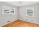 Well-lit bedroom featuring hardwood floors and two windows at 107 Gladstone Sw Dr, Marietta, GA 30060