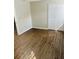 Well-lit bedroom with wood-look floors and double doors at 603 Brighton Ct, Norcross, GA 30071