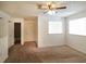 Spacious, unfurnished bedroom with neutral walls, carpeted flooring, and a ceiling fan at 6502 Wellington Chase Ct, Lithonia, GA 30058