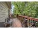 Relaxing deck with wooden railings, wicker chairs, and a bicycle at 581 Cooper Sw St, Atlanta, GA 30312