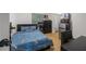 Cozy bedroom with a full bed, dresser, and mini fridge at 581 Cooper Sw St, Atlanta, GA 30312