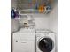 Laundry room with washer, dryer, and ample shelving at 581 Cooper Sw St, Atlanta, GA 30312