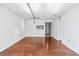 Spacious living room showcasing hardwood floors and kitchen pass-through at 2870 Pharr Court South Nw # 607, Atlanta, GA 30305