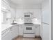 White kitchen with corner sink, appliances, and ample cabinetry at 2870 Pharr Court South Nw # 607, Atlanta, GA 30305