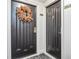Two apartment doors with wreaths, gold accents, and dark wood finish at 2870 Pharr Court South Nw # 607, Atlanta, GA 30305