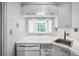White kitchen with a pass-through window to the living area at 2870 Pharr Court South Nw # 607, Atlanta, GA 30305