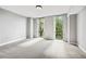 Bright bedroom with gray carpet and large windows at 2870 Pharr Court South Nw # 607, Atlanta, GA 30305