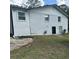 Rear of house with white brick, black door, and landscaping at 3503 Larkspur Ter, Decatur, GA 30032