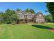 Two-story house with brick and stone accents, lush landscaping, and a welcoming front porch at 4284 Maclaren Ct, Powder Springs, GA 30127