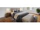 Main bedroom with hardwood floors and plush bedding at 1875 Langston Sw Ave, Atlanta, GA 30310