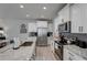 Modern kitchen with white cabinets, granite island, and stainless steel appliances at 5142 Longview Run, Decatur, GA 30035
