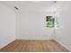 Bright bedroom with a window and wood-look flooring at 1410 Elizabeth Sw Ave, Atlanta, GA 30310