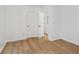 Spacious bedroom with wood-look flooring and access to hallway at 1410 Elizabeth Sw Ave, Atlanta, GA 30310