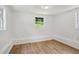 Simple bedroom with light walls and wood-look flooring at 1410 Elizabeth Sw Ave, Atlanta, GA 30310