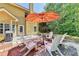 Cozy patio with seating for four under a shade umbrella at 2762 Sedgeview Ln, Buford, GA 30519