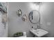 Small bathroom with white sink and vanity, gray walls, and decorative mirror at 5150 Longview Run, Decatur, GA 30035