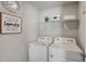 Bright laundry room, featuring washer, dryer, and ample shelving at 5150 Longview Run, Decatur, GA 30035
