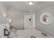 Bright bedroom with a queen bed, large mirror, and access to another room at 5150 Longview Run, Decatur, GA 30035