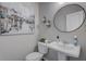 Stylish powder room with pedestal sink, toilet, and framed art at 5150 Longview Run, Decatur, GA 30035