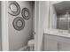 Small bathroom with a toilet, sink, and decorative mirrors at 5150 Longview Run, Decatur, GA 30035