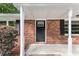 Front entrance with a black door and white columns at 4028 Creel Dr, Lithia Springs, GA 30122